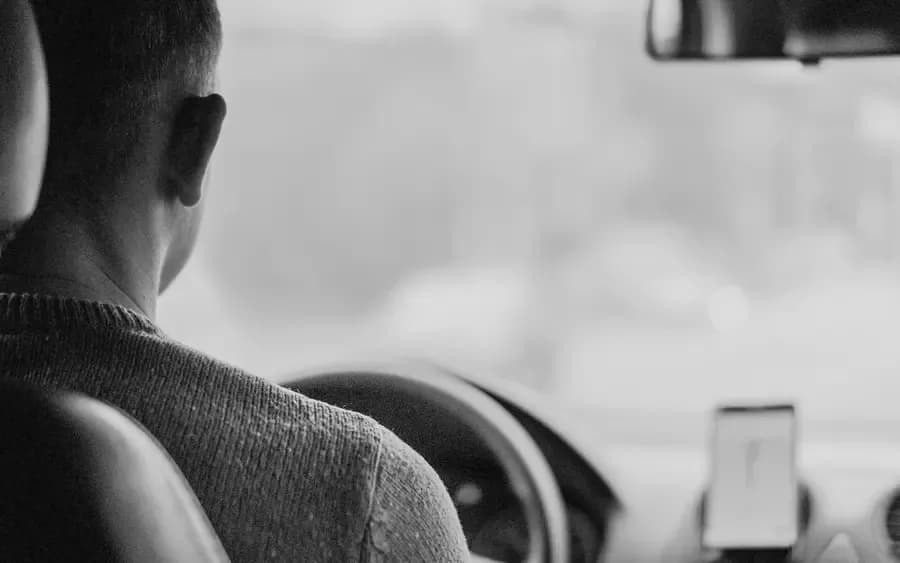 Guest enjoying chauffeur service in luxury vehicle, showcasing premium transport included with select holiday lets