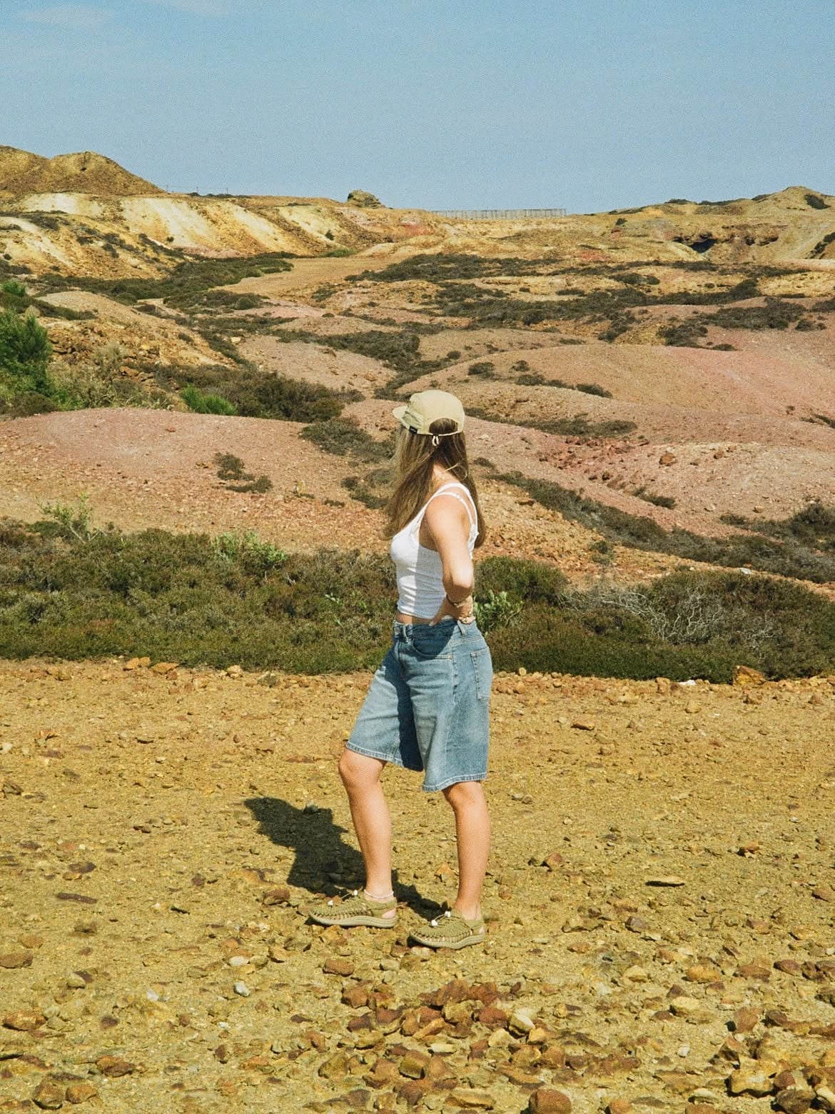 Guest exploring the vivid ochre and rust-coloured mineral landscape of Parys Mountain copper mine on Anglesey