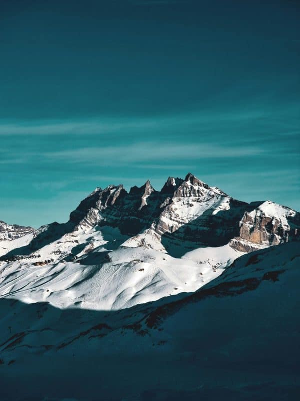 Snow-capped Alpine peaks under turquoise sky, perfect backdrop for luxury ski chalet holidays in the French Alps