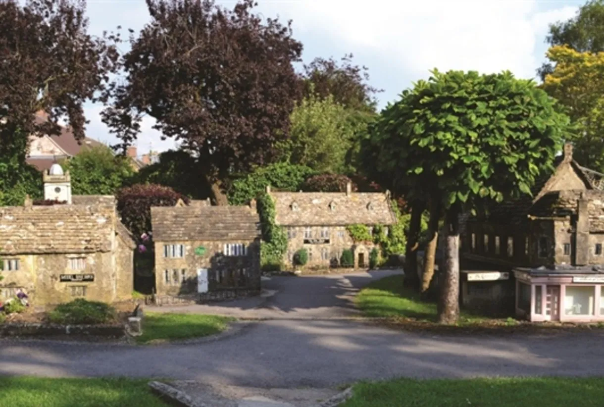 Miniature model village with Cotswold stone buildings and mature trees, a family-friendly attraction near Bourton-on-the-Wat…